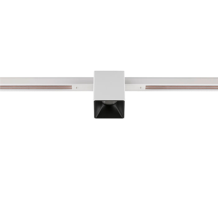 White square track lighting fixture, surface mounted.