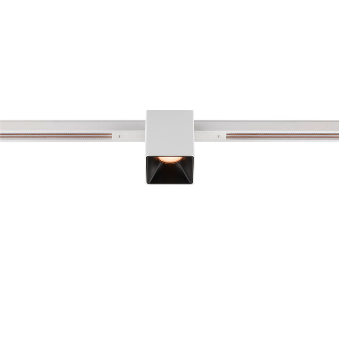 White square track lighting fixture mounted on a white track.