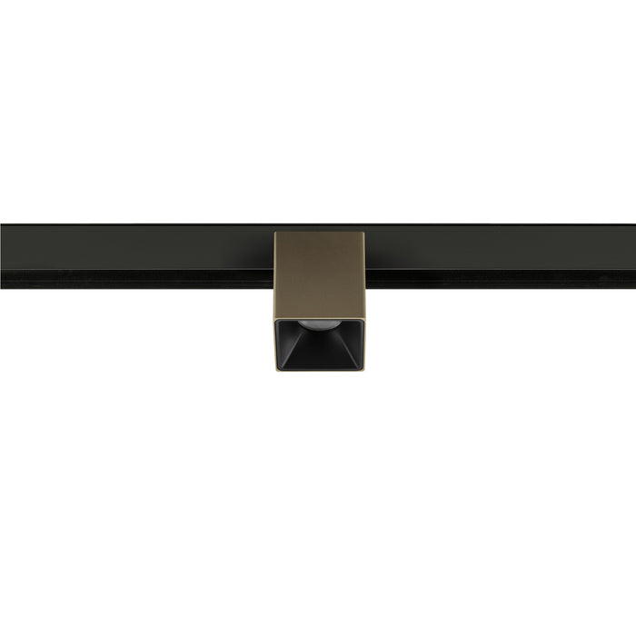 Metal track lighting fixture, bronze finish, mounted on black track.