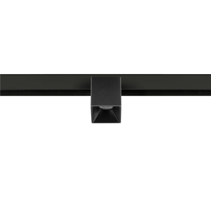 Black square track lighting fixture, mounted on a track.