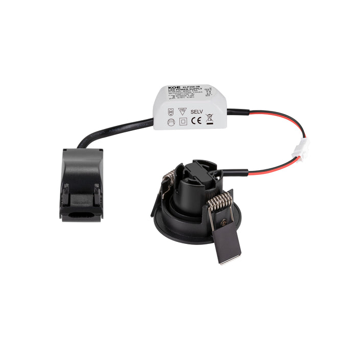 Black recessed LED downlight with spring mounting clips and white power supply.