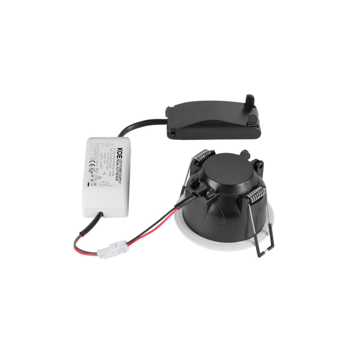 Recessed LED downlight with black trim, white baffle, spring mounting clips, and external power supply.