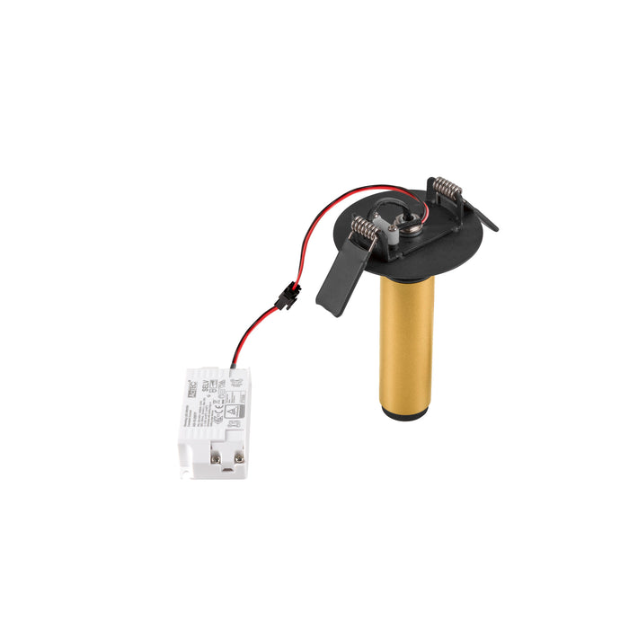 Recessed light fixture with gold metal cylinder, black mounting plate, spring clips, and white driver.