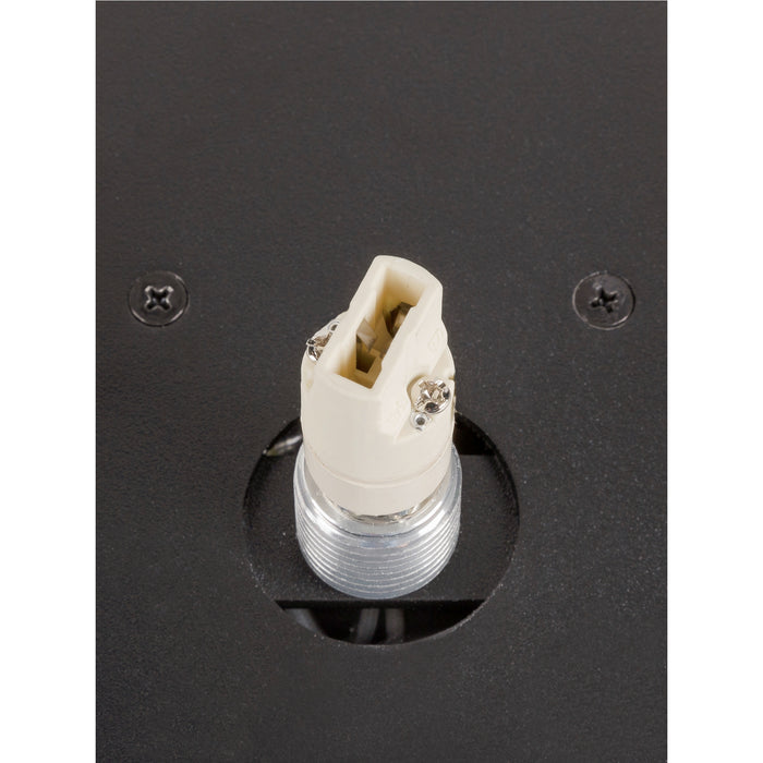 Close-up of a black metal fixture with a white plastic socket and threaded metal base.