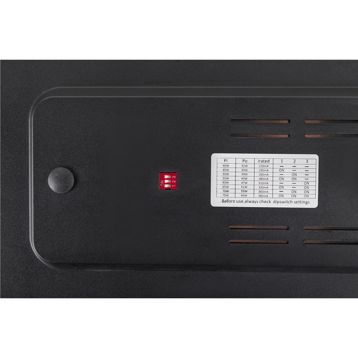 Close-up of a black plastic panel with dip switches, power settings table, and ventilation slots.