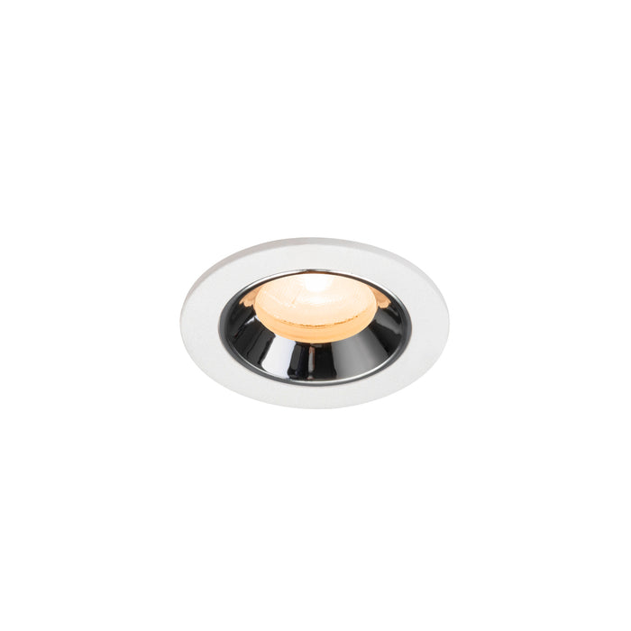 Recessed ceiling light fixture made of metal with a chrome finish and white trim, featuring a warm white LED bulb.