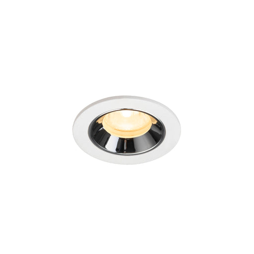 Recessed ceiling light fixture with a chrome finish, white metal trim, and warm LED bulb.