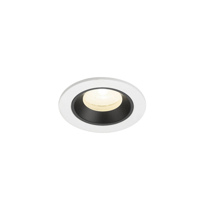 Recessed ceiling light fixture with a white metal finish and black interior, featuring a warm white LED bulb for efficient illumination.