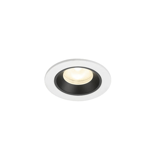 Recessed ceiling light fixture with a white metal finish and black interior, featuring a round design and warm white LED bulb.