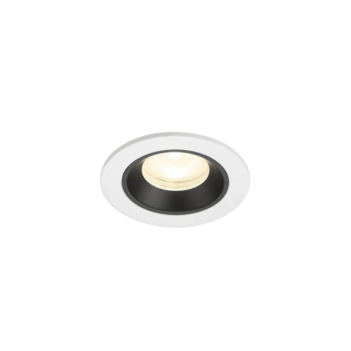 Recessed ceiling light fixture with a white metal finish and black interior, featuring a round design and warm white LED bulb.
