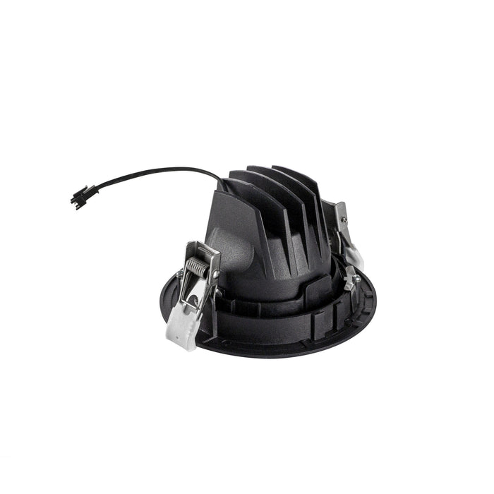 Black recessed downlight with metal mounting clips.
