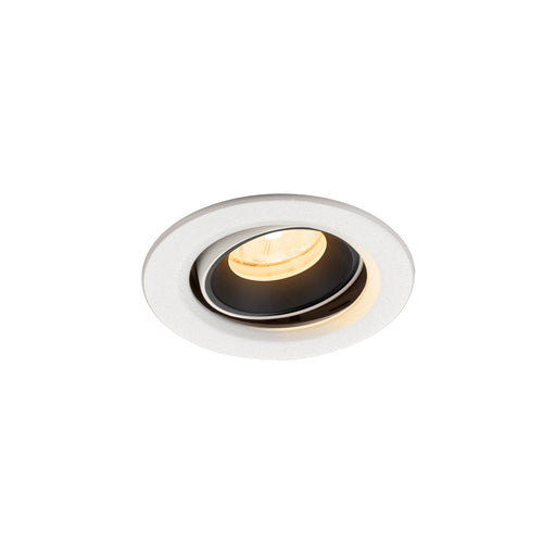 Recessed ceiling light fixture in white finish with a black interior, featuring a round design and warm LED bulb.