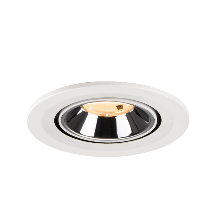 Recessed ceiling light fixture with a white finish, chrome reflector, and warm LED bulb.