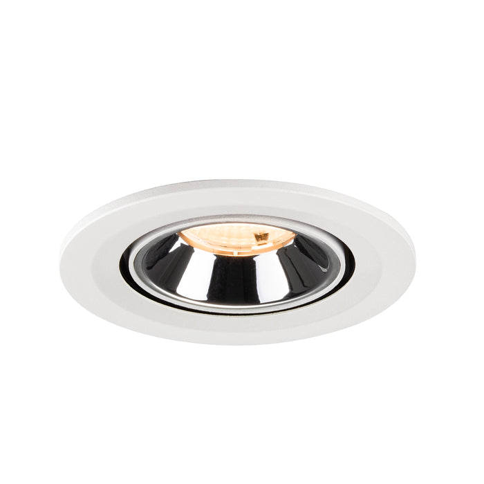 Recessed ceiling light fixture with a white finish, chrome reflector, and warm LED bulb.