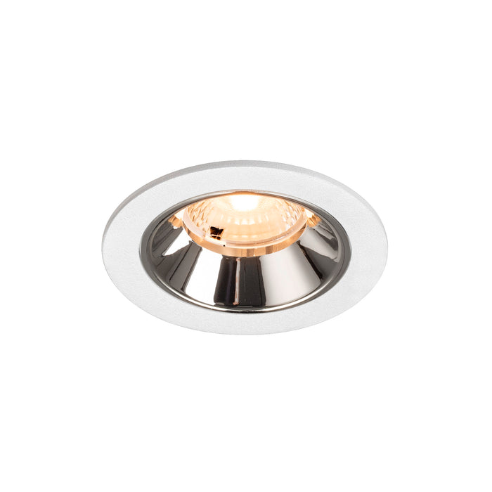 Recessed ceiling light fixture with a chrome finish, white metal trim, and a warm LED bulb for modern interior lighting.