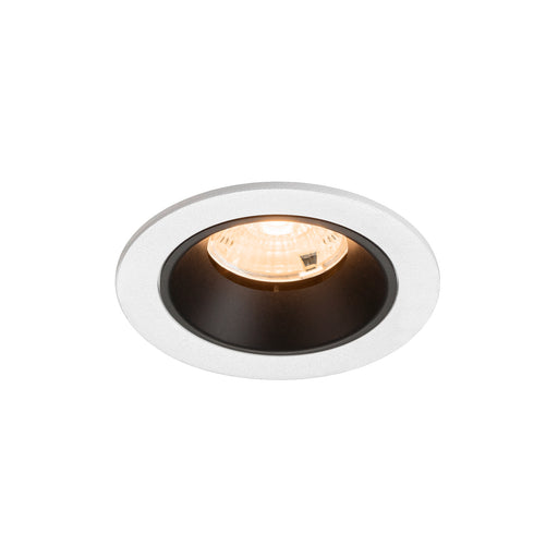 Recessed ceiling light fixture with a white metal trim and black interior, featuring a glass lens and warm LED bulb.