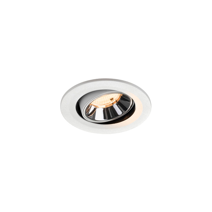 Recessed ceiling light fixture with a chrome finish, white aluminum housing, and warm LED bulb.