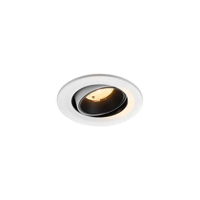 Recessed ceiling light fixture in white metal with a black interior, featuring a sleek design and warm LED illumination.