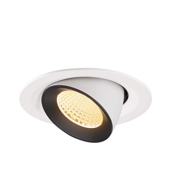 Recessed ceiling light fixture made of metal with a matte white finish and black interior, featuring a warm LED bulb.