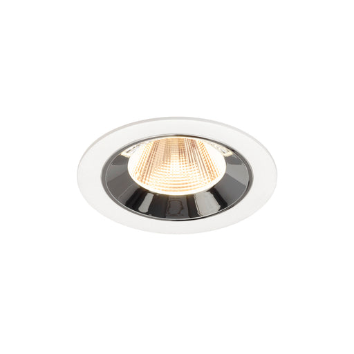 Recessed ceiling light fixture made of metal with a chrome finish and white trim, featuring a warm LED bulb for modern illumination.