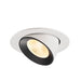 Recessed ceiling light fixture with a black and white finish, made of metal, featuring a textured reflector for warm illumination.