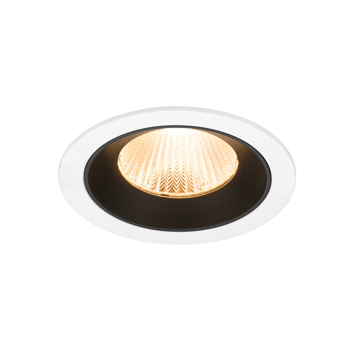 Recessed ceiling light fixture with a white finish, black interior, and glass lens, featuring a warm white LED bulb for ambient lighting.