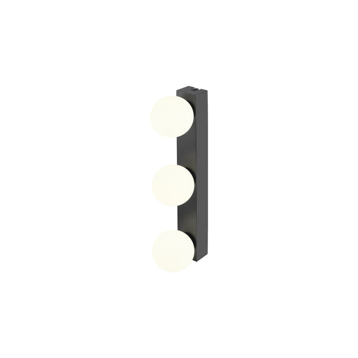 Black metal wall sconce with three round white glass shades.