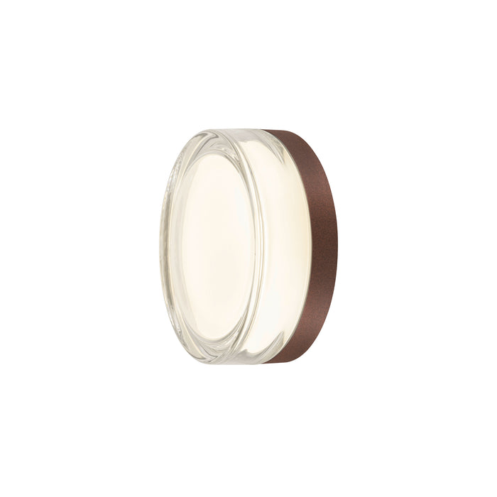Clear glass wall sconce with bronze finish.