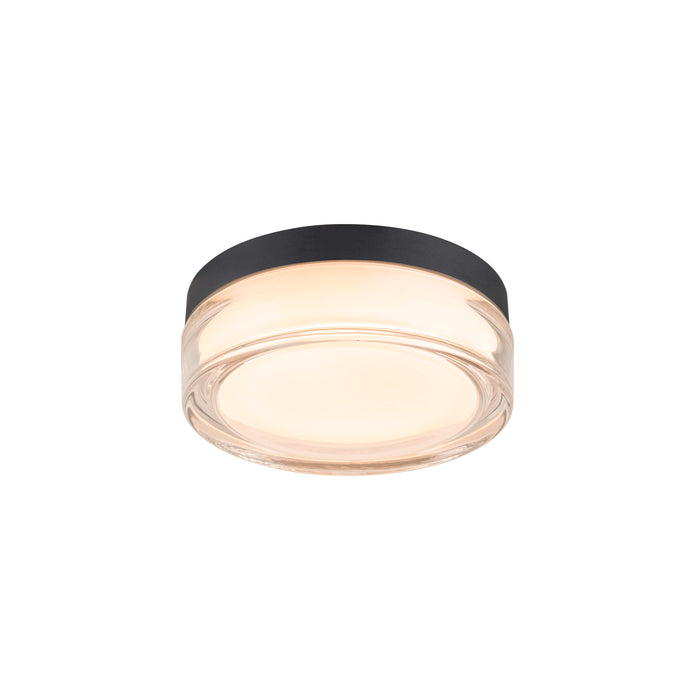Clear glass flush mount ceiling light with black trim.