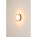 Round glass wall sconce with warm light.