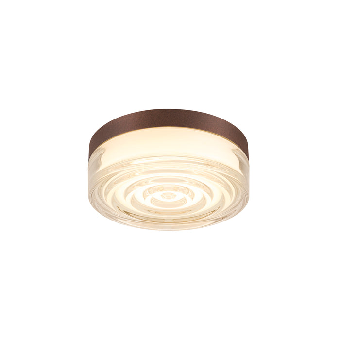 Flush mount ceiling light fixture with clear glass shade and bronze-colored metal trim.