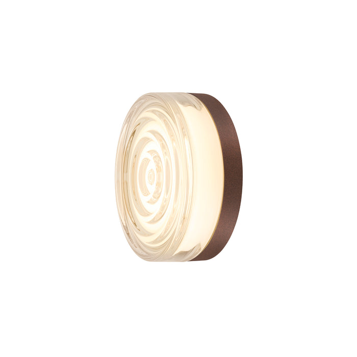 Textured glass wall sconce with a bronze-finished metal backplate.