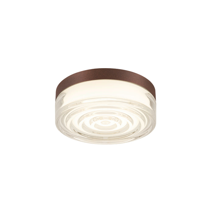 Glass flush mount ceiling light fixture with brown trim.