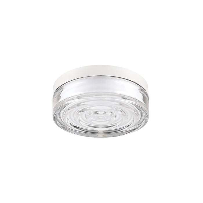 Clear glass flush mount ceiling light with white trim.