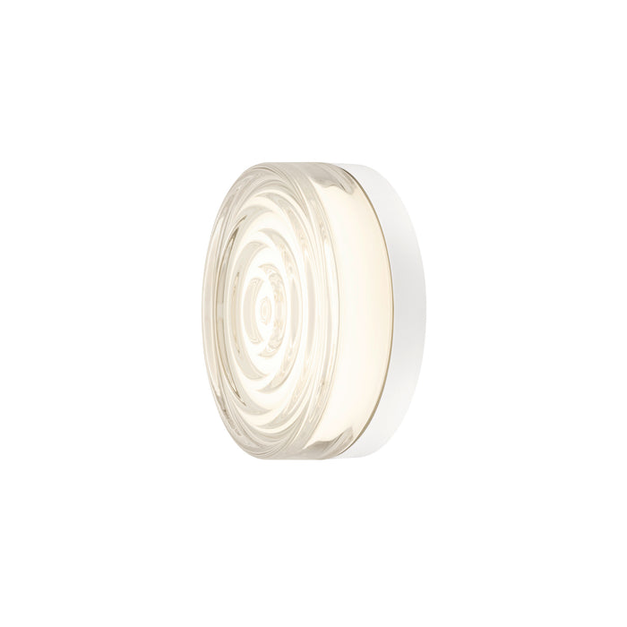Round glass wall sconce with white trim.