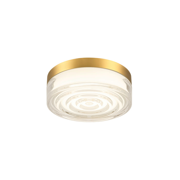 Clear glass flush mount ceiling light with gold finish.