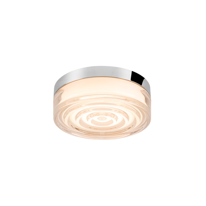 Glass flush mount ceiling light with chrome finish and concentric circle design.