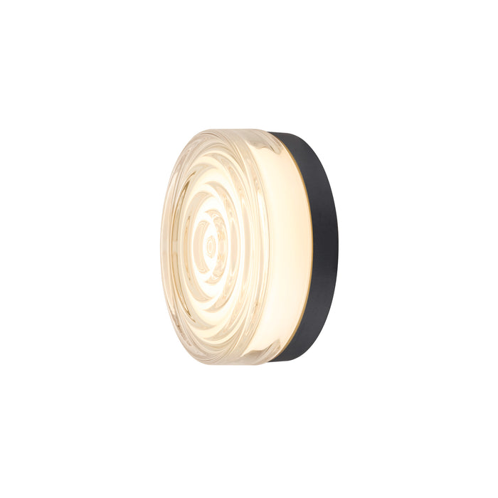 Clear glass wall sconce with black mounting.