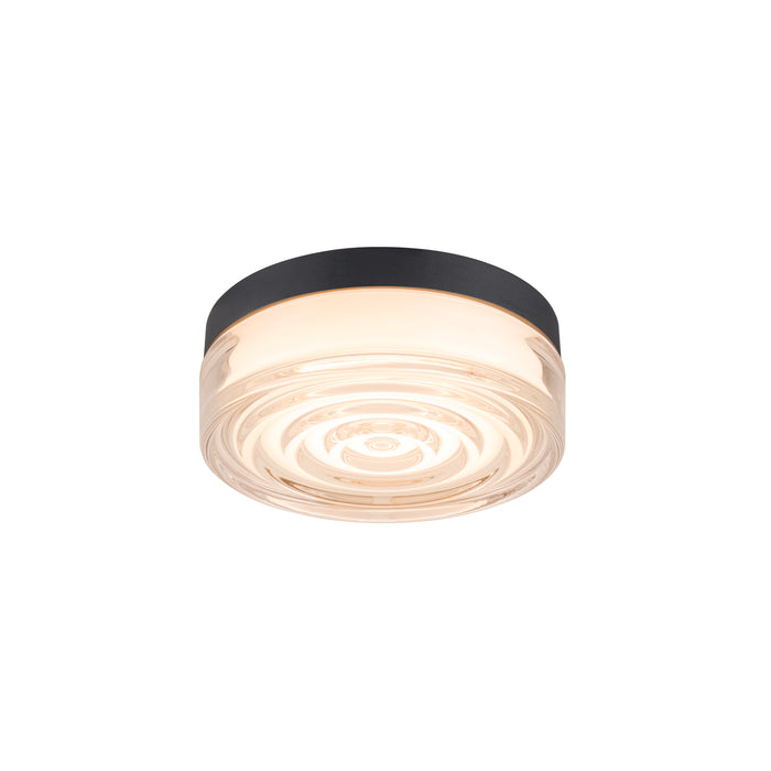 Flush mount ceiling light with clear glass shade, concentric circle design, and black metal trim.