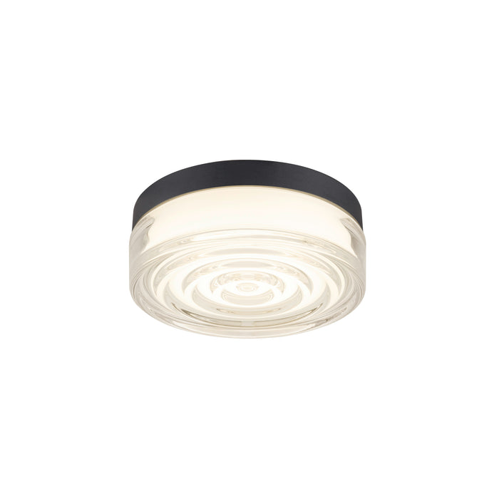 Flush mount ceiling light fixture with clear glass shade and black metal trim.
