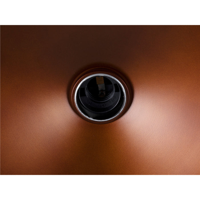 Close-up of a copper-colored metal light fixture with a brushed finish and a visible bulb socket.