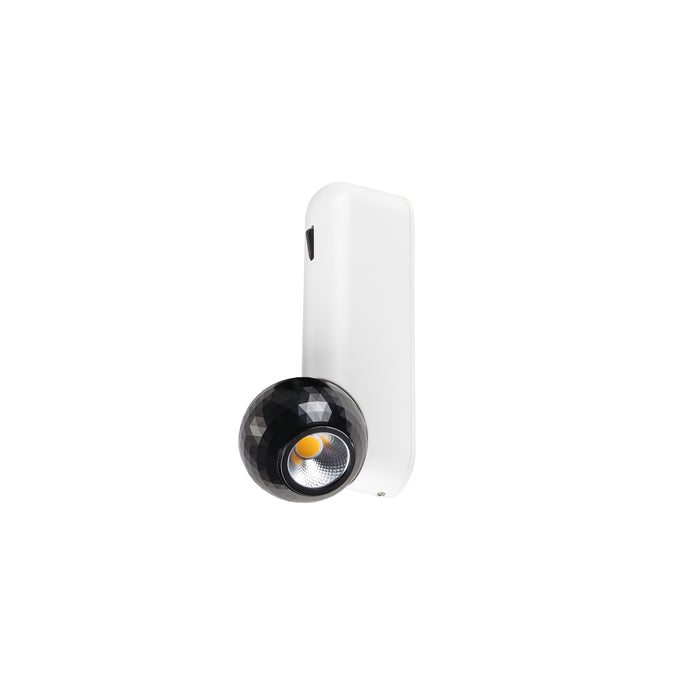 Modern wall-mounted spotlight with a black faceted shade and a white rectangular base.