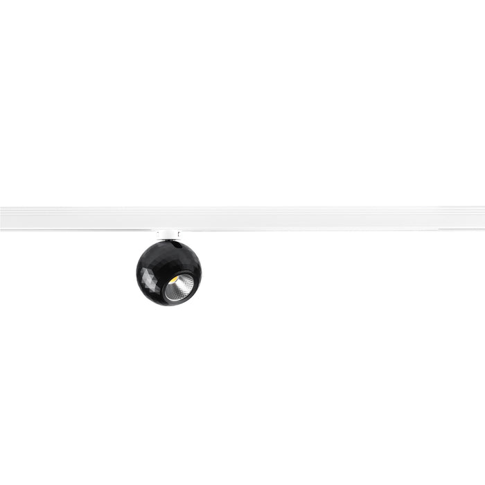 Black faceted track light fixture on white track.