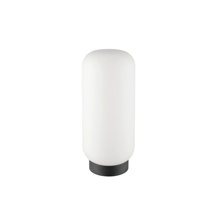 White glass table lamp with a black base.