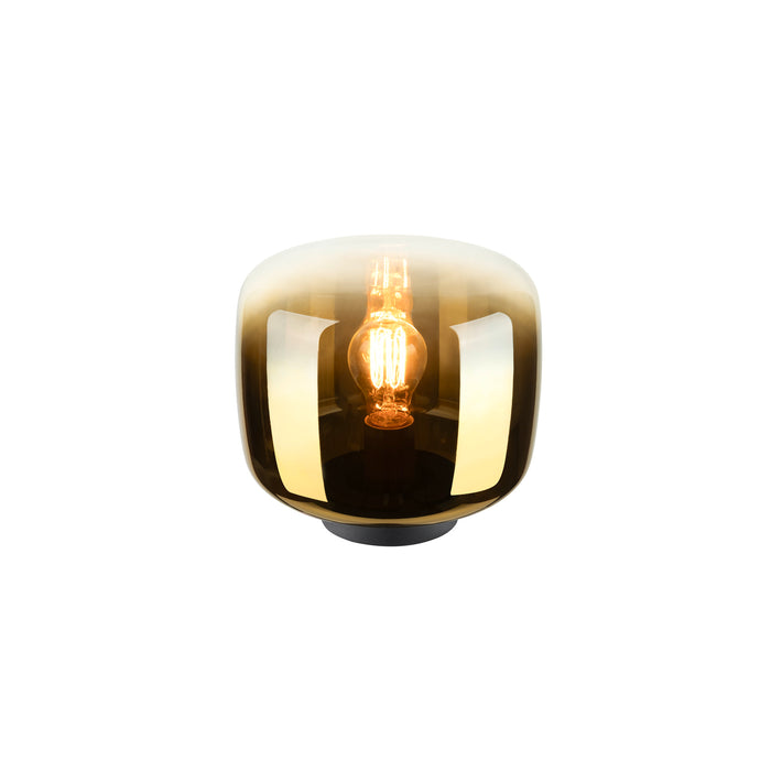 Glass table lamp with a gold ombre finish and black base.