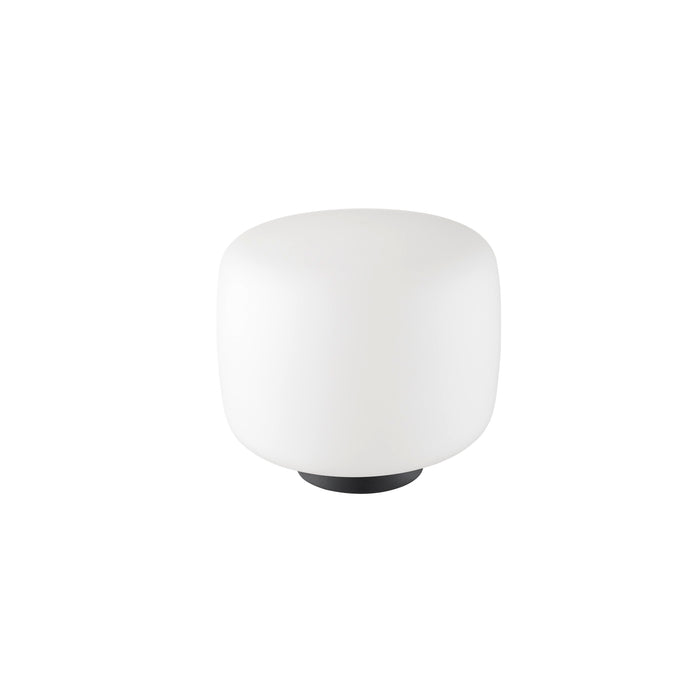 White glass table lamp with black base.