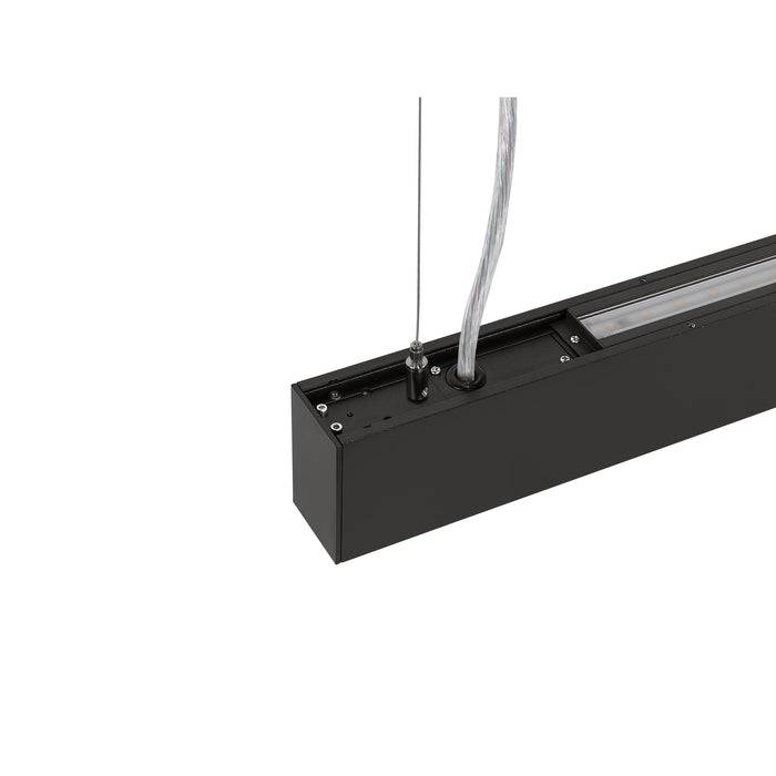 Close-up of a black, suspended linear LED light fixture with a matte finish.