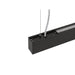 Close-up of a black, suspended linear LED light fixture with a matte finish.