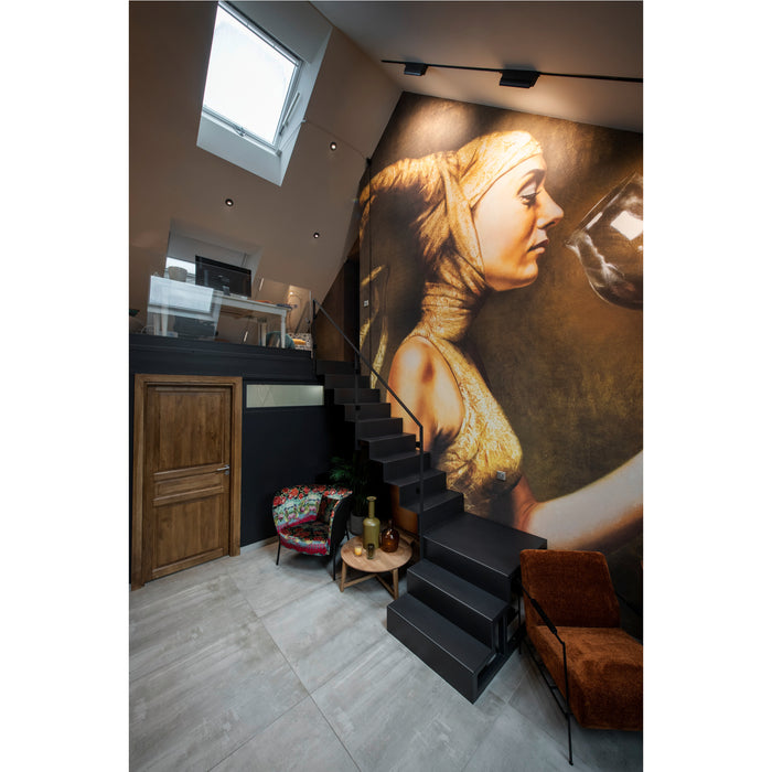 Modern loft interior with black metal stairs, wood door, and large wall art.