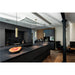 Modern kitchen with black marble countertops, matte gray cabinets, and brass pendant lights.